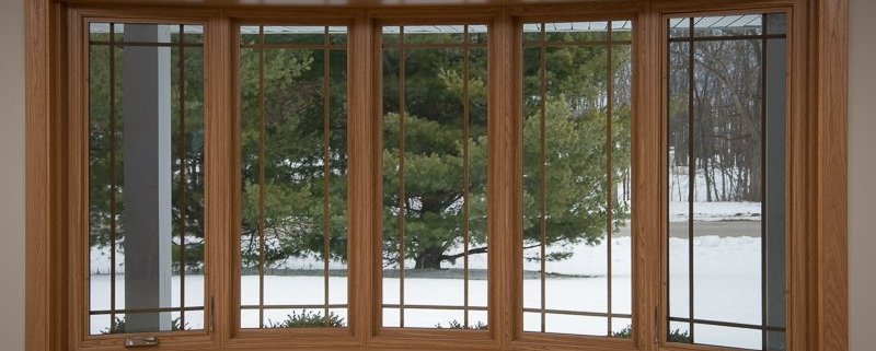 Bow window with prairie grids, vinyl windows, wood grain grids and golden oak interior in Franklin, WI