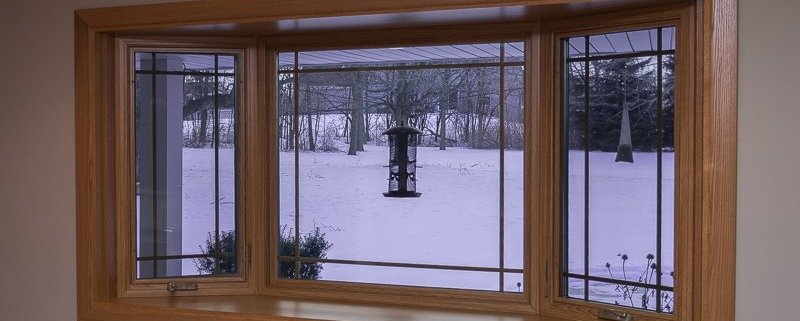 Bay window with prairie grids, golden oak interior stain and laminated seat in Franklin, WI