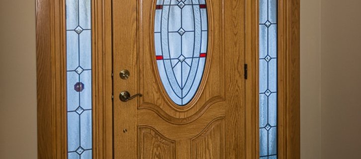 Entry Door with two sidelites & oval leaded glass & natural oak interior stain in Franklin, WI