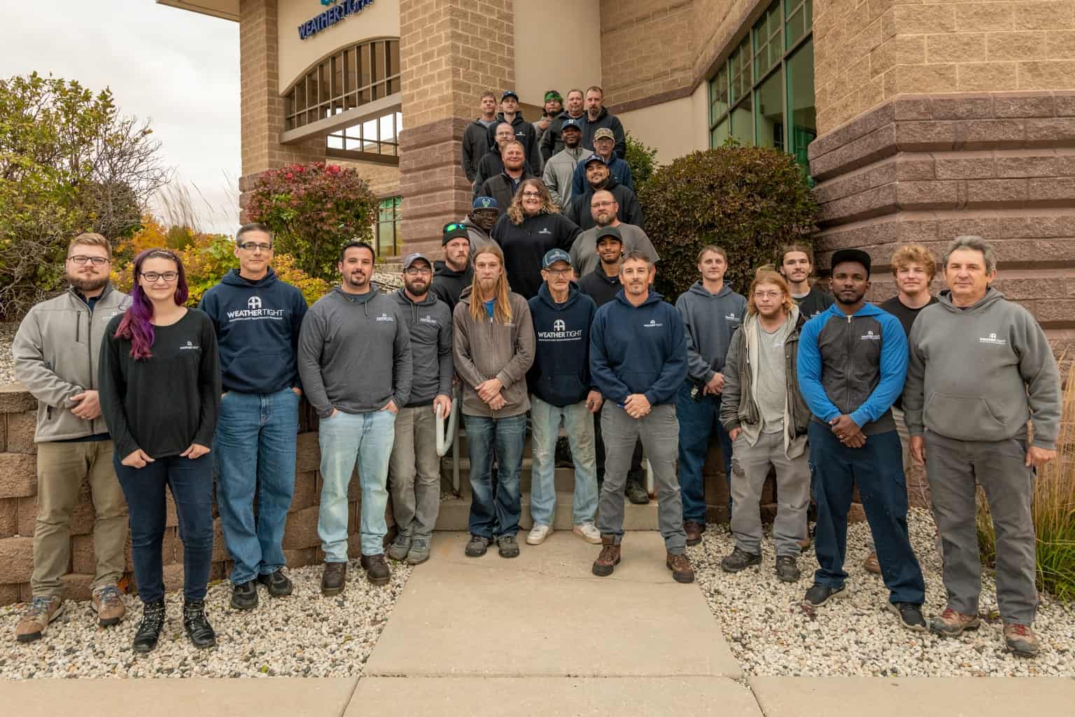 Image shows members of the Weather Tight team photographed outside of the Ideas Center in West Allis. 